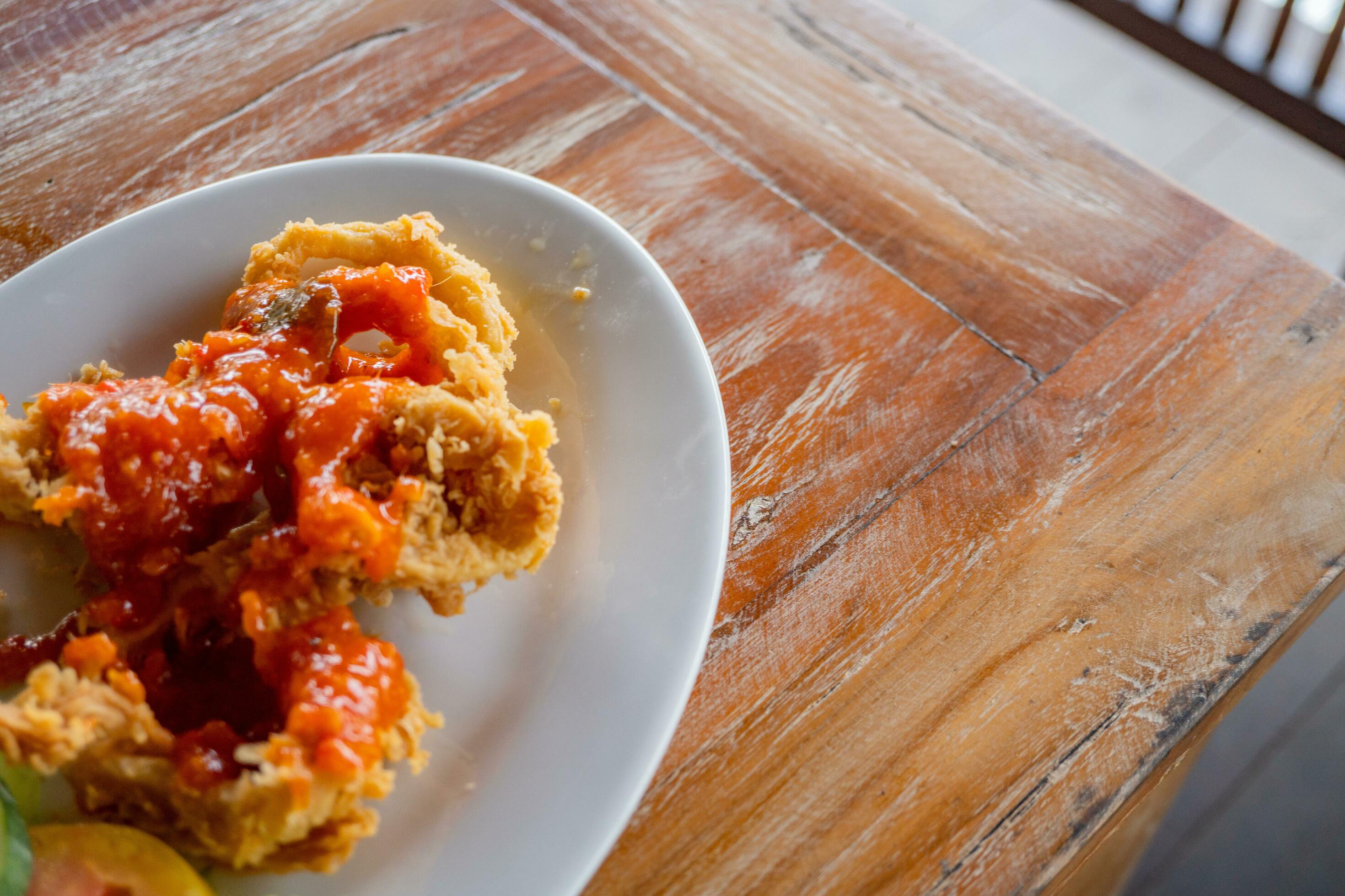 Fried squid with sweet spicy sauce, traditional sea food of Indonesian