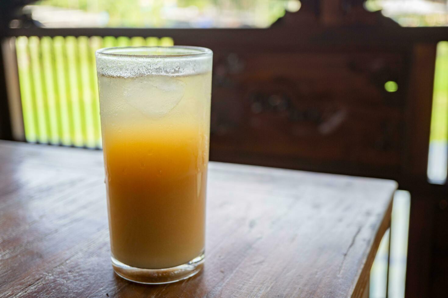 Traditional drink of Indonesia Jamu Beras Kencur Iced, fresh and tasty. The photo is suitable to use for drink background, menu poster and content media.