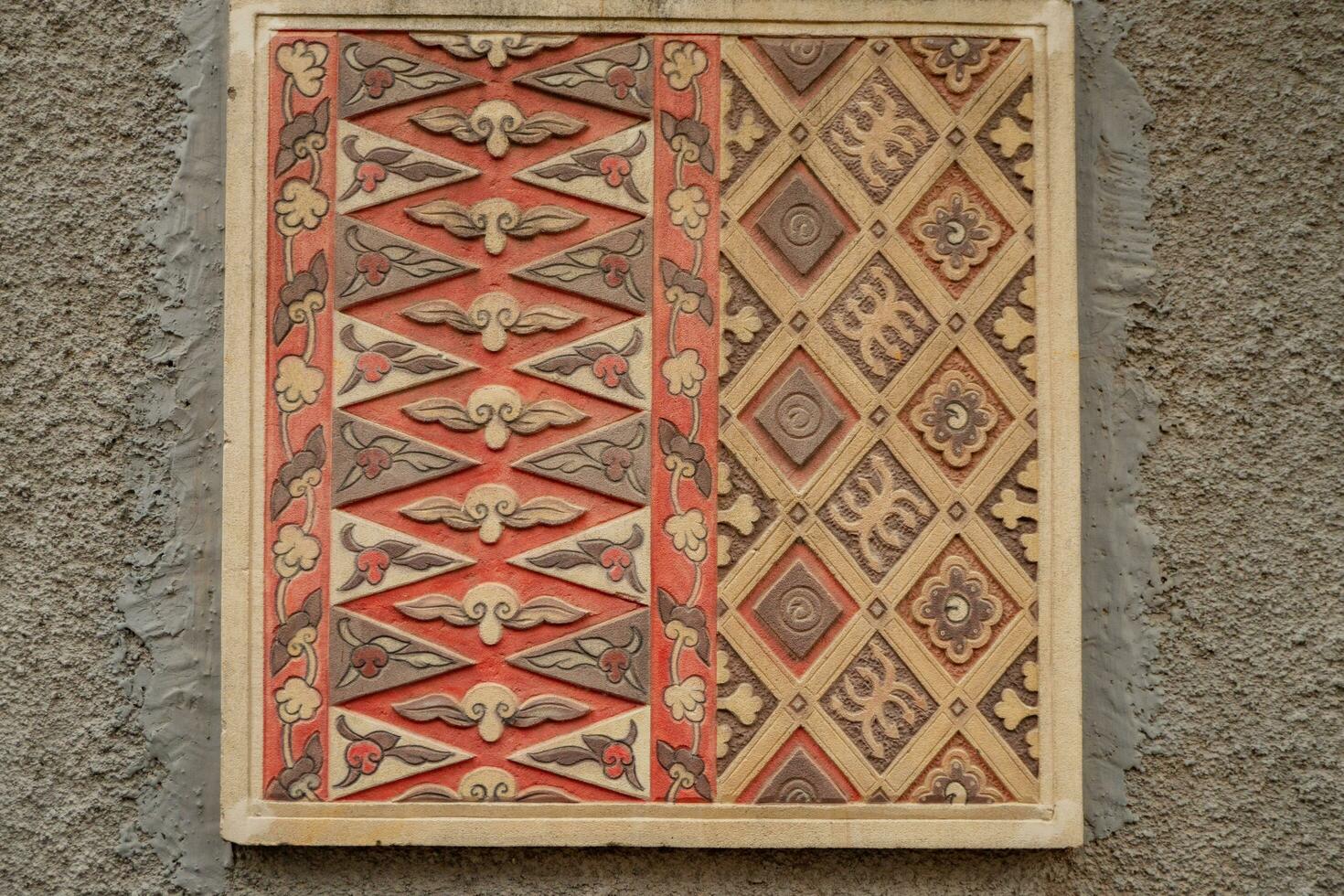 Texture and surface of batik carving on wall at Semarang. The photo is suitable to use for culture background, travel destination poster and travel content media.