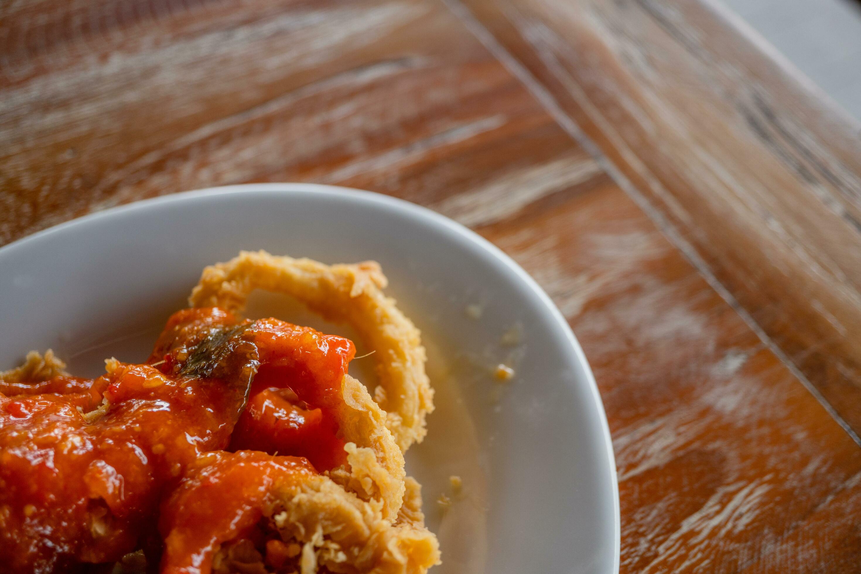 Fried squid with sweet spicy sauce, traditional sea food of Indonesian