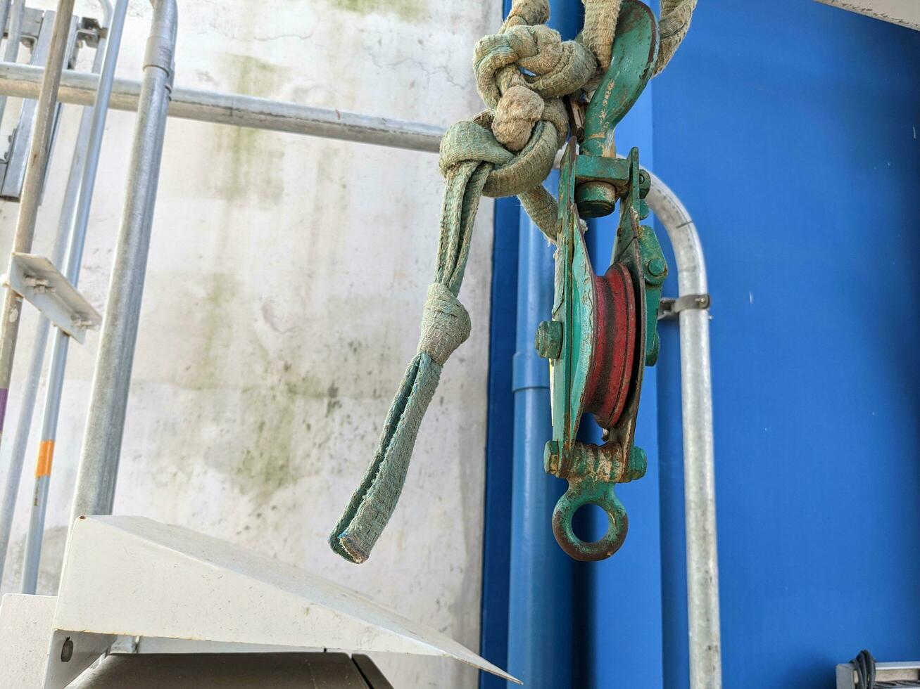 Small pulley on wire robe for lifting material on power plant project. The photo is suitable to use for industrial background and construction content media.