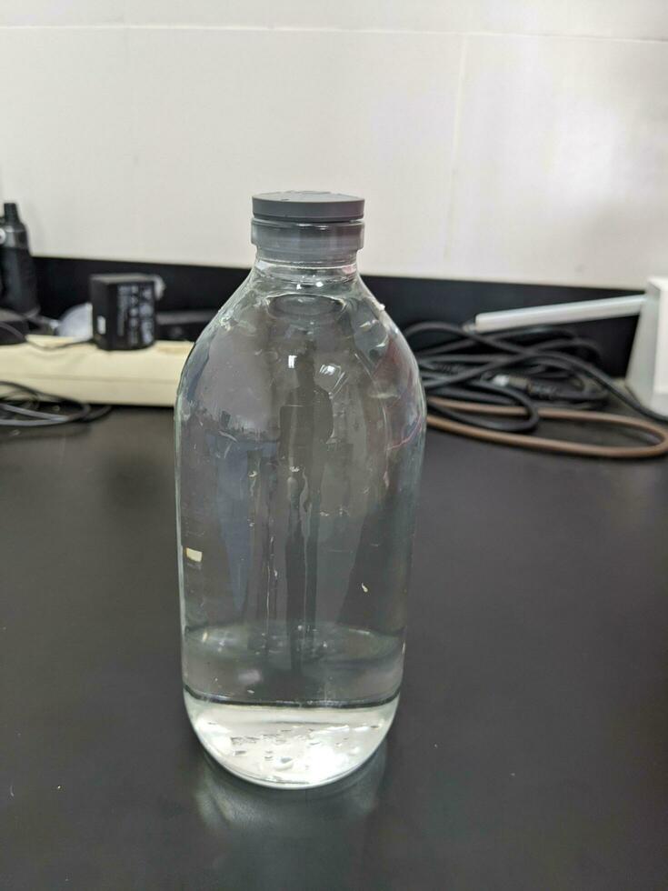 Clear water on the bottle transparent for laboratory usage. The photo is suitable to use for laboratory background and content media.