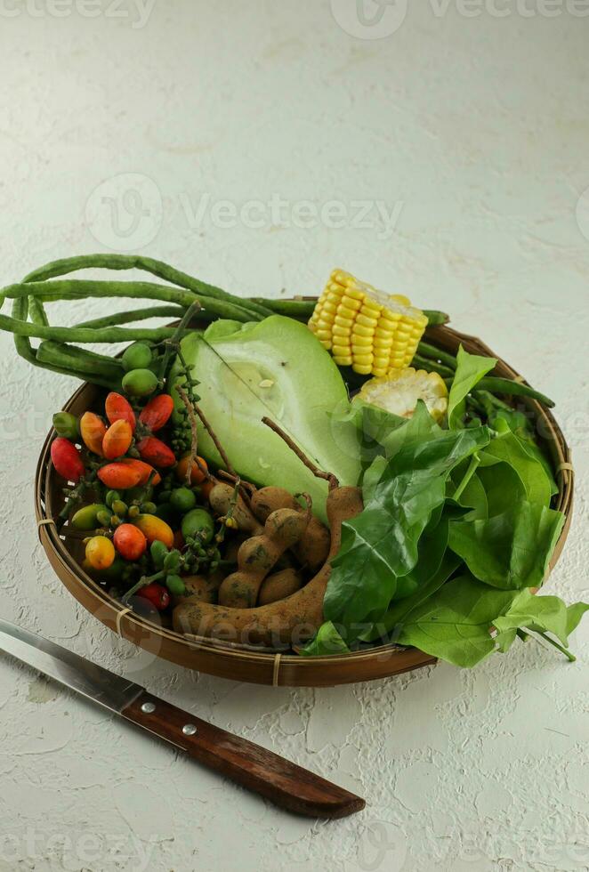 raw vegetables, to make tamarind vegetable or ingredients for making tamarind vegetables, cooking preparation traditional food from indonesia. photo