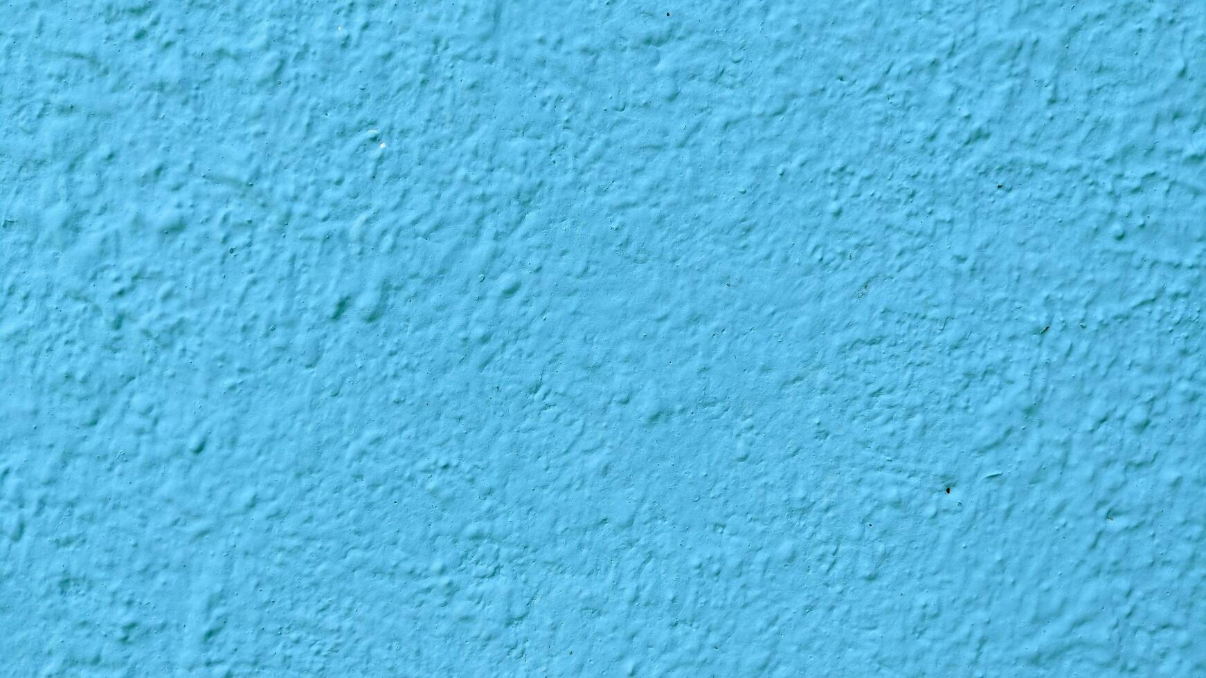 Blue stucco texture of a wall with copy space for background photo