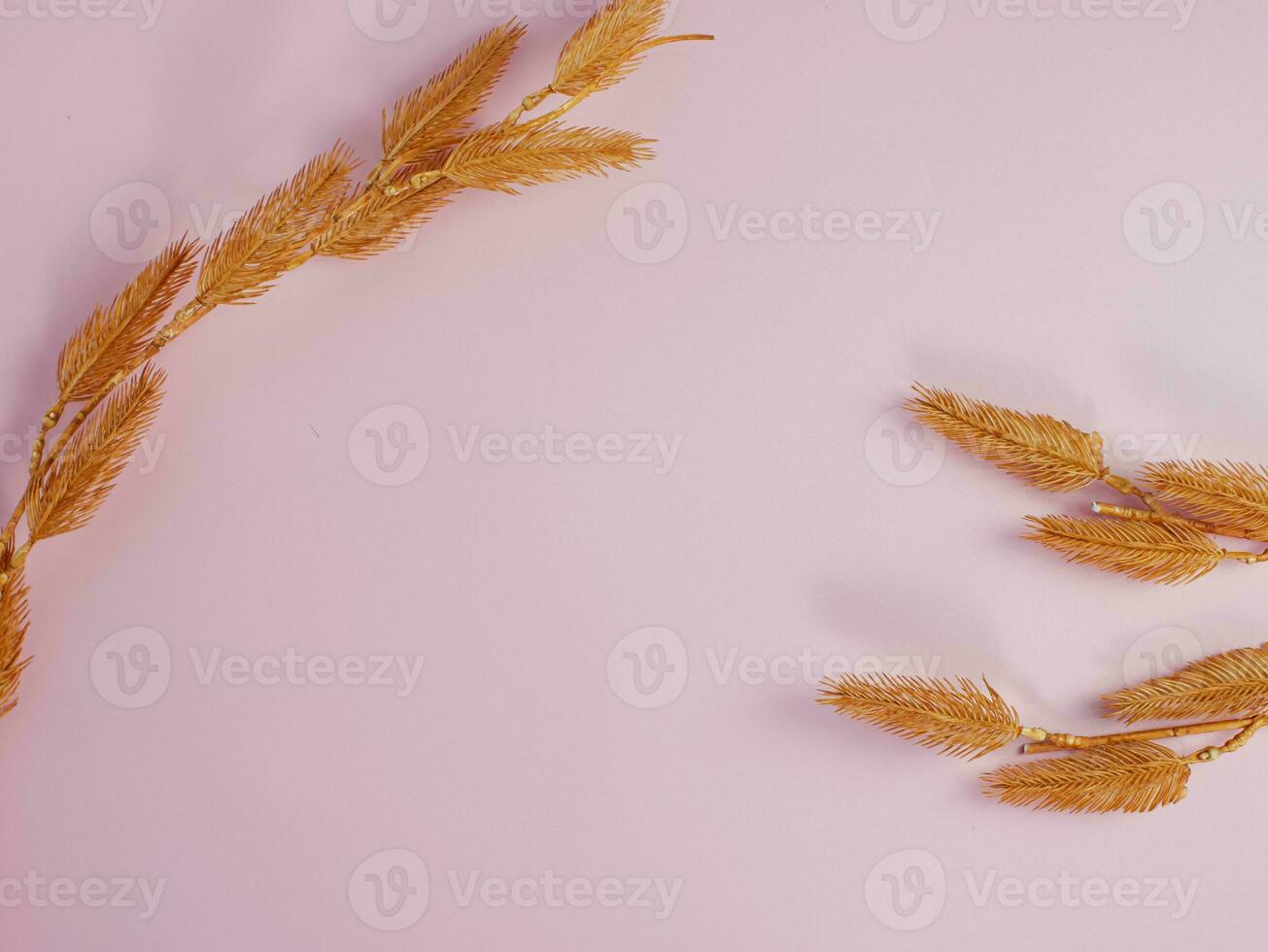 golden decorative flowers on pink pastel background with copy space photo