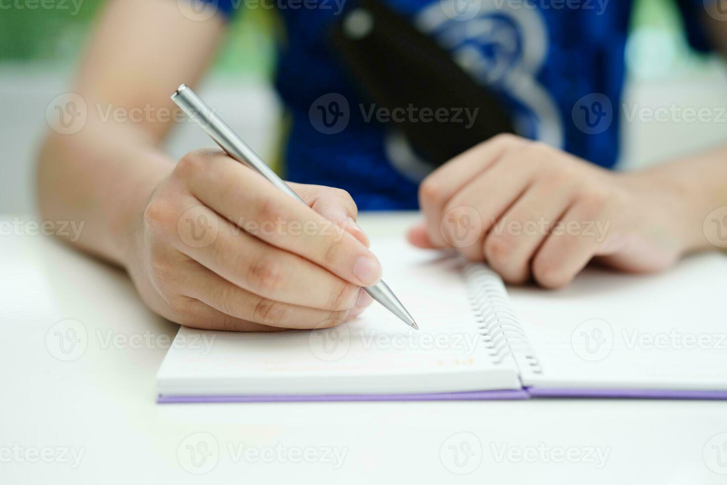 Asian teenage student write homework, study lesson for exam online learning education. photo