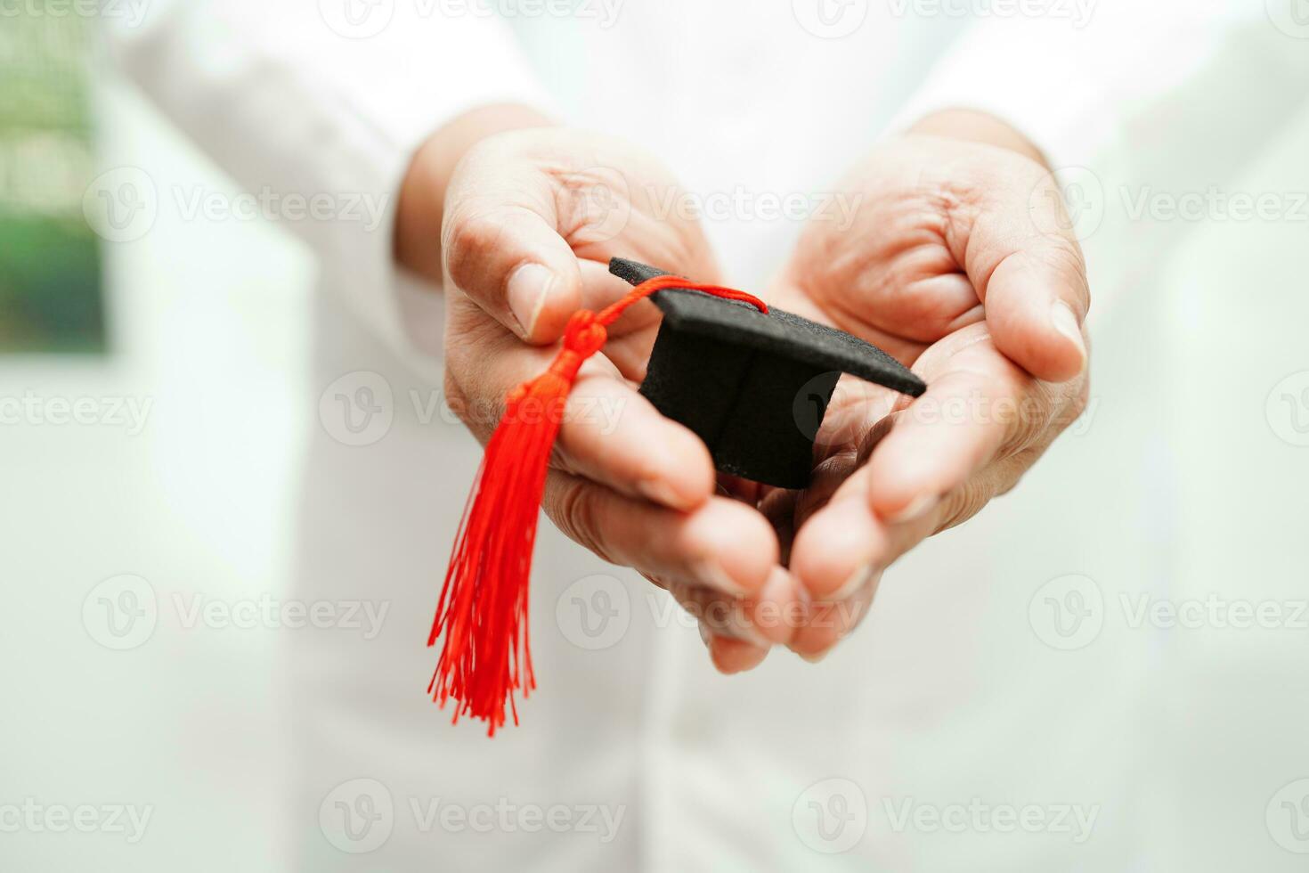 Asian woman doctor holding graduation hat in hospital, Medical education concept. photo