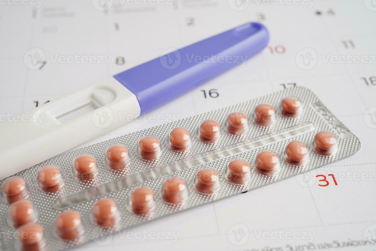 Pregnancy test for female on calendar, ovulation day. photo