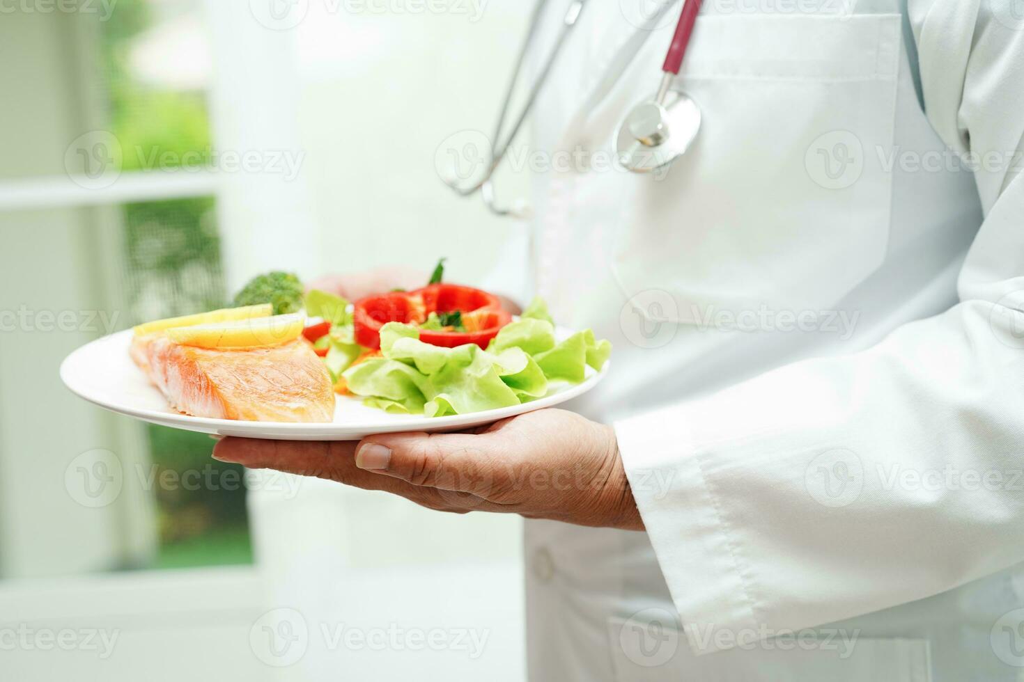 Asian Nutritionist holding healthy food for patient in hospital, nutrition and vitamin. photo