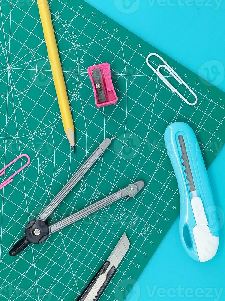 Green Cutting mats , Pen drawings , adjust angle tool , scale ruler on blue background photo