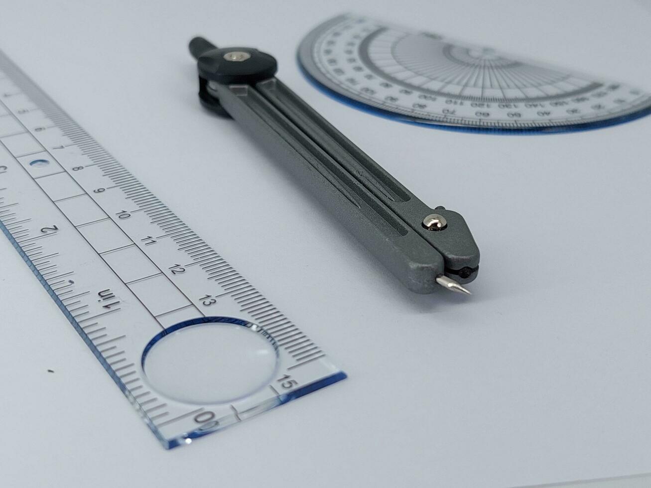 drawing compass and ruler on table photo