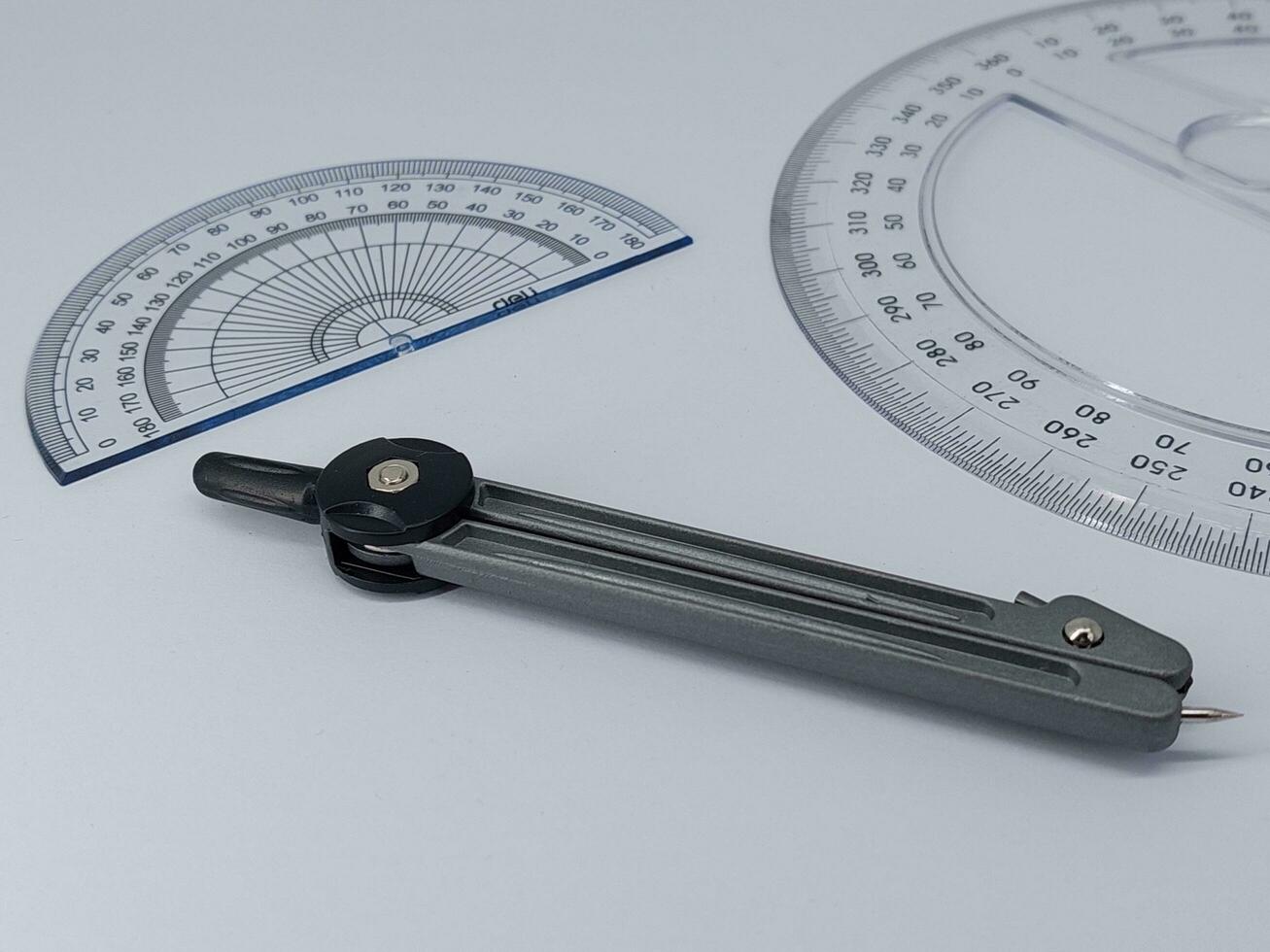 drawing compass and ruler on table photo