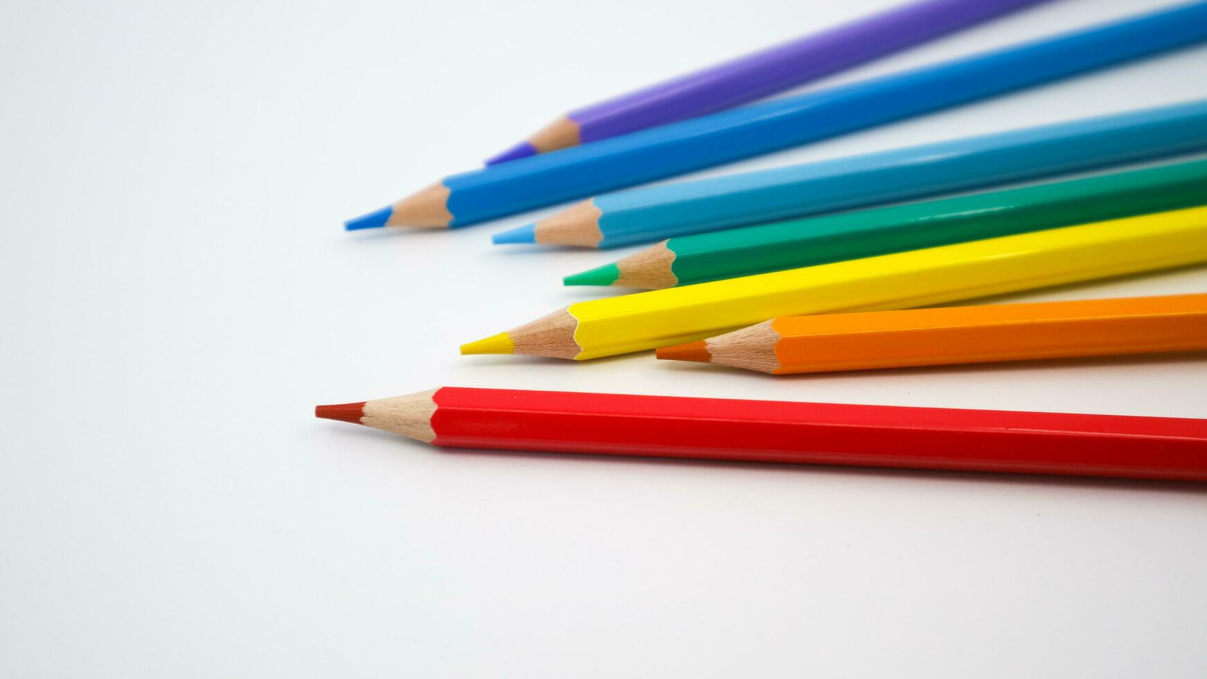 Many different colored pencils on white background photo