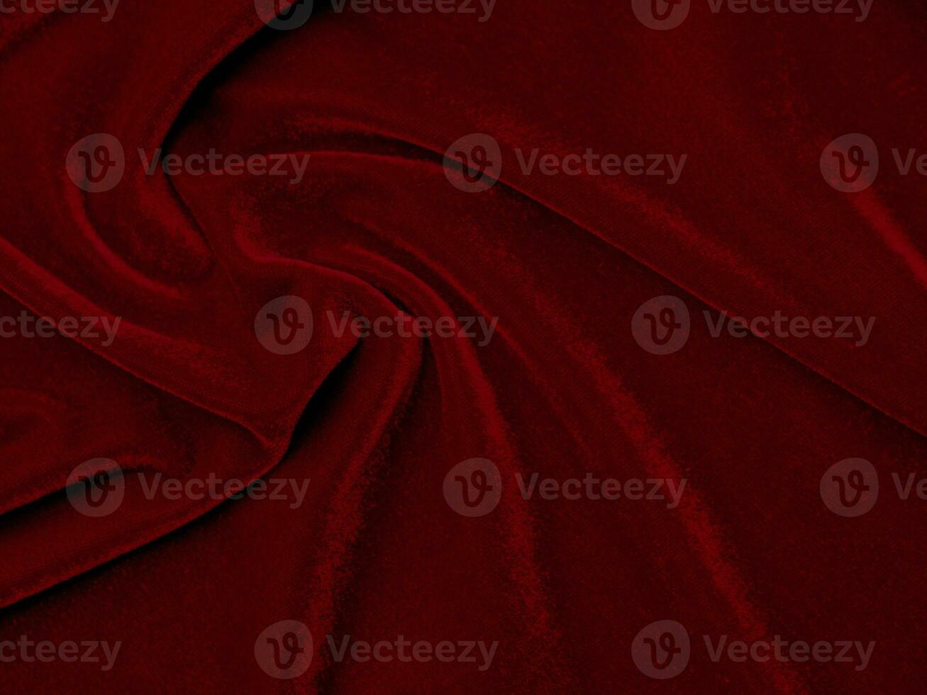 textura de tela de terciopelo rojo utilizada como fondo. fondo de tela roja vacía de material textil suave y liso. hay espacio para el texto.. foto