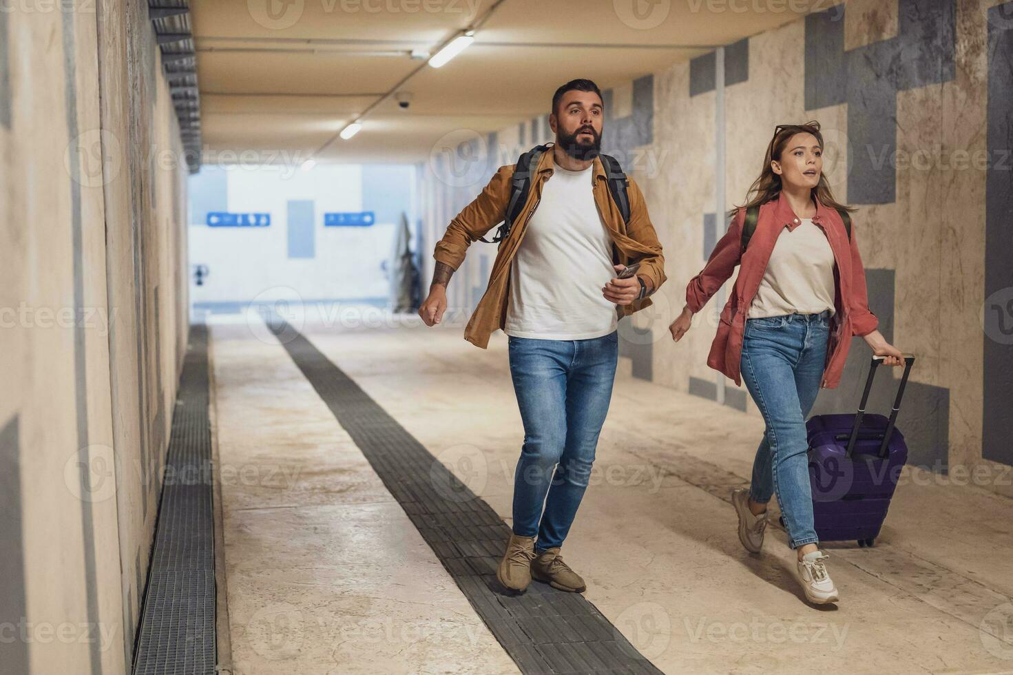 Adult couple is in a hurry to catch the train on time. photo