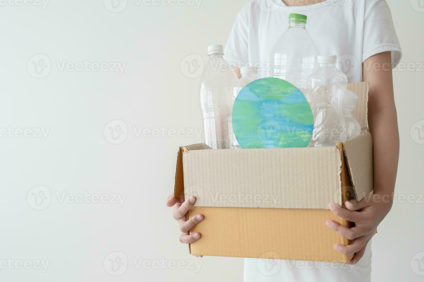 People launch a campaign to recycle used empty plastic bottles. Hands holding cardboard box full with plastic bottle ready to recycle. Concept of reuse, reduce, recycle to save the environment photo