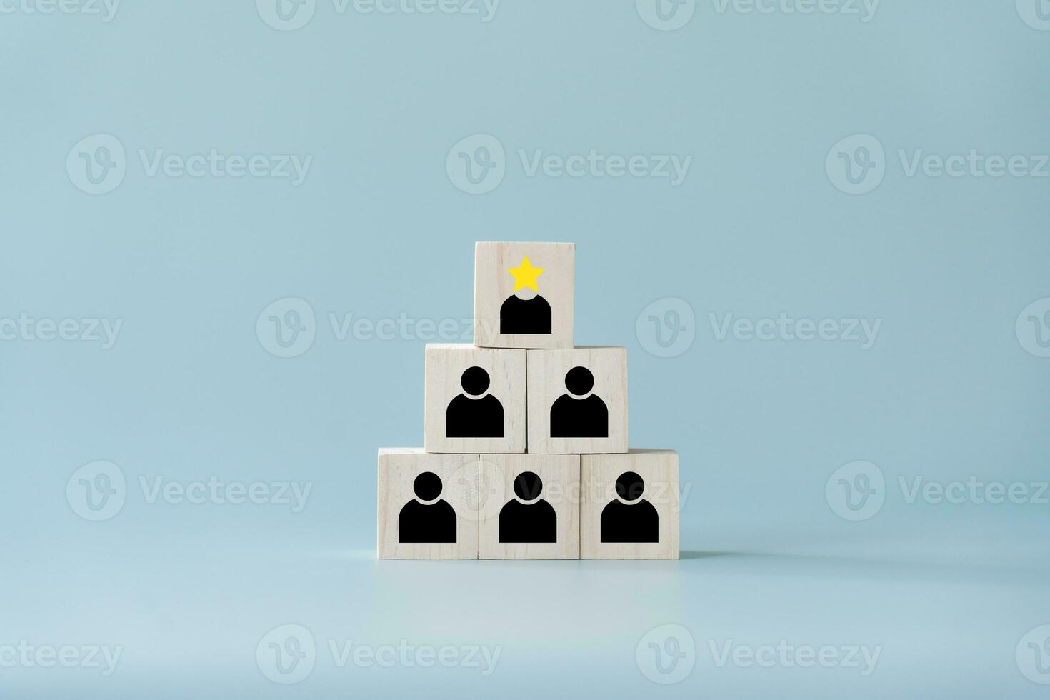 Concept and idea of leadership at the top with star best performance  and followers in black wooden blocks. The top of square wooden toy blocks is leader of below representing as followers. photo