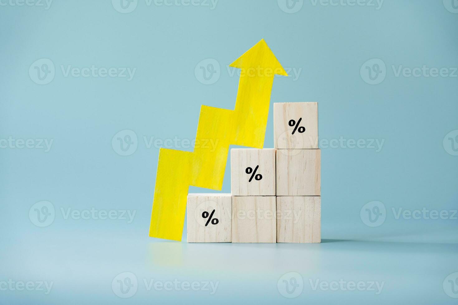 Yellow paper cut arrow going up positive trend on wooden blocks with percentages. Concept of profit increasing in percentage. photo