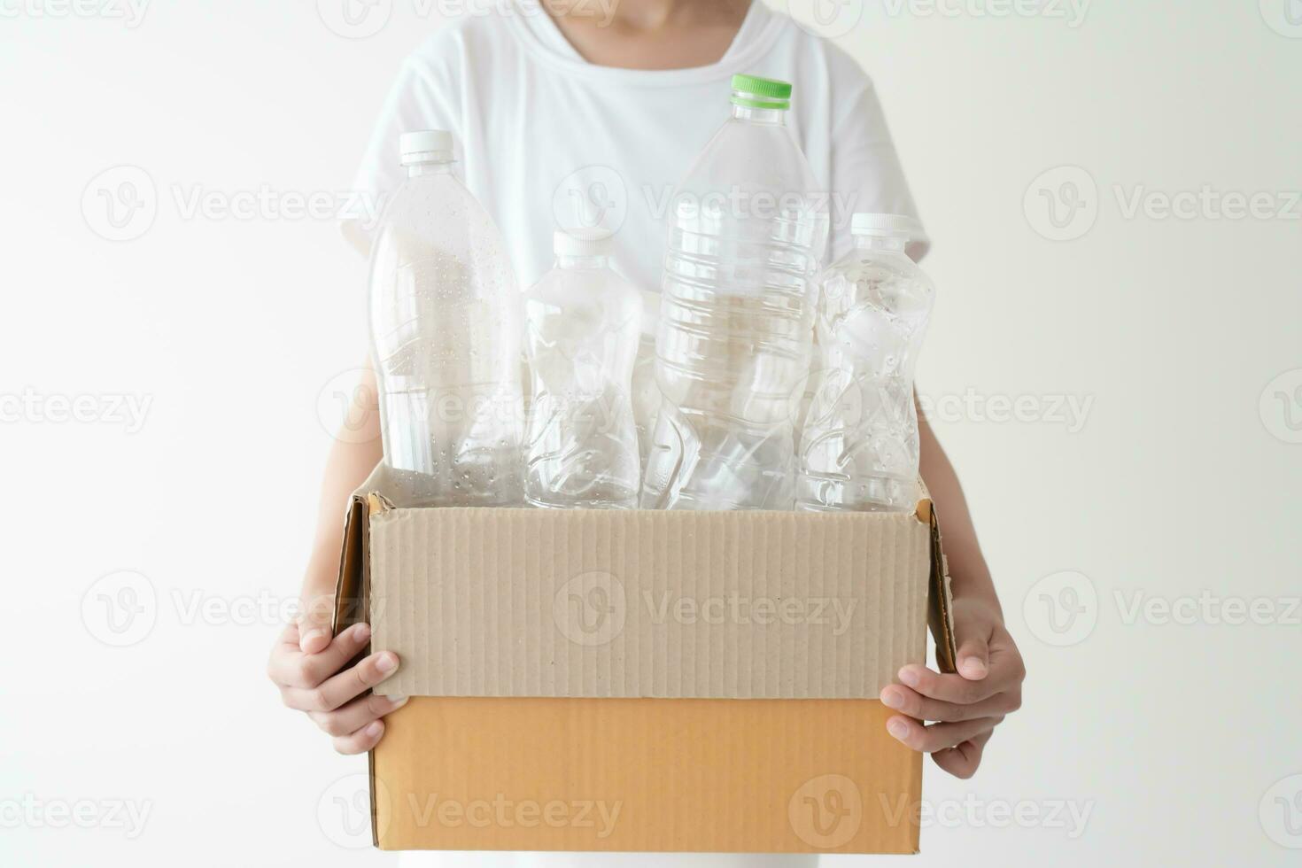 People launch a campaign to recycle used empty plastic bottles. Hands holding cardboard box full with plastic bottle ready to recycle. Concept of reuse, reduce, recycle to save the environment photo