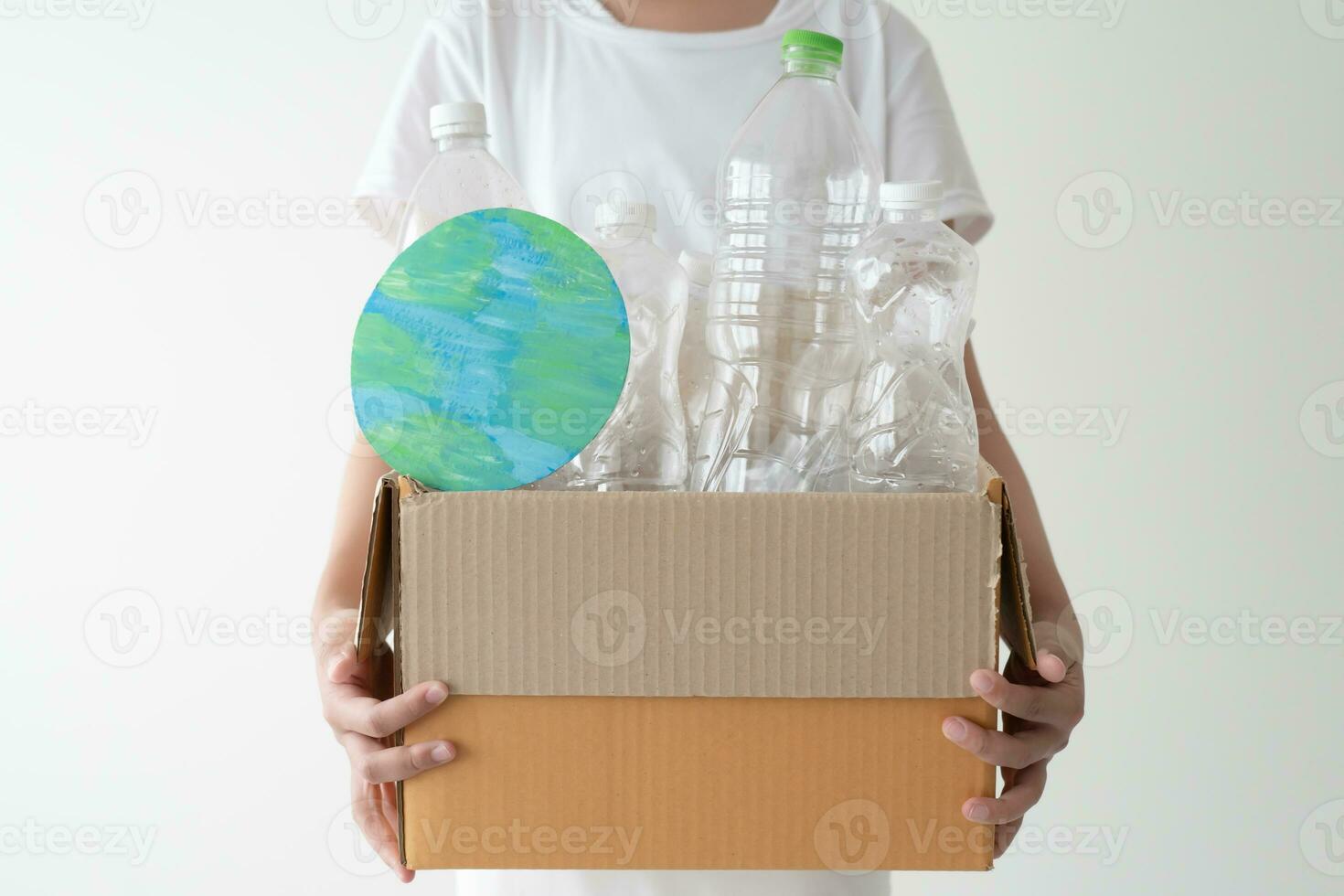 People launch a campaign to recycle used empty plastic bottles. Hands holding cardboard box full with plastic bottle ready to recycle. Concept of reuse, reduce, recycle to save the environment photo