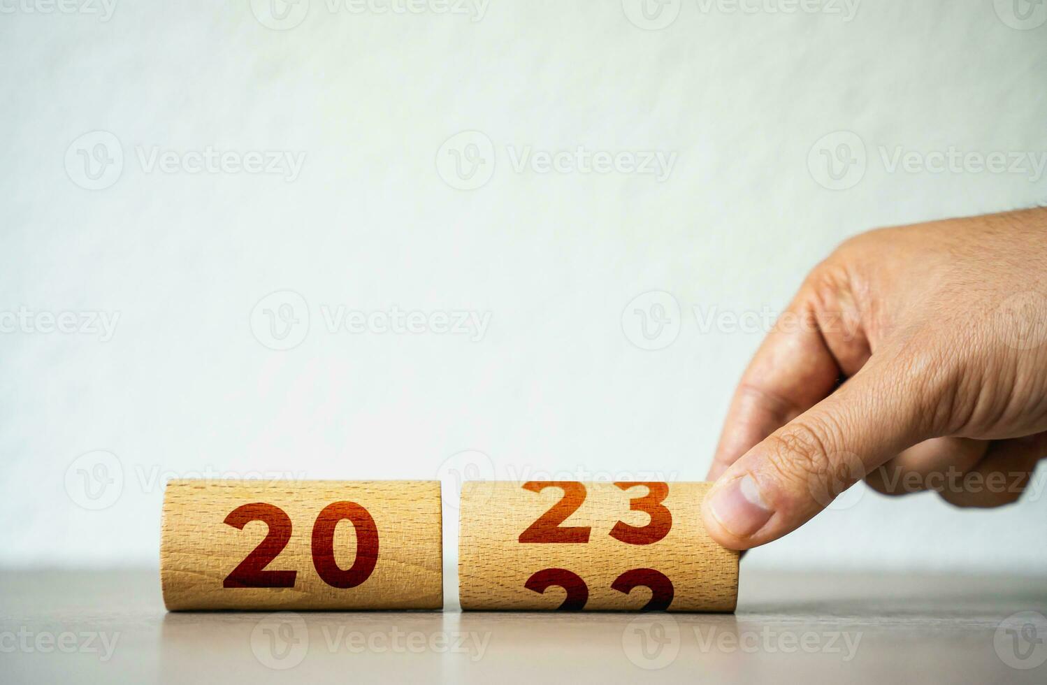 Wooden calendar flip for 2023. Christmas holidays. Trends and changes, challenges. A new beginning. Rethinking life and setting priorities. Set new plans and goals. Reaching business objectives. photo