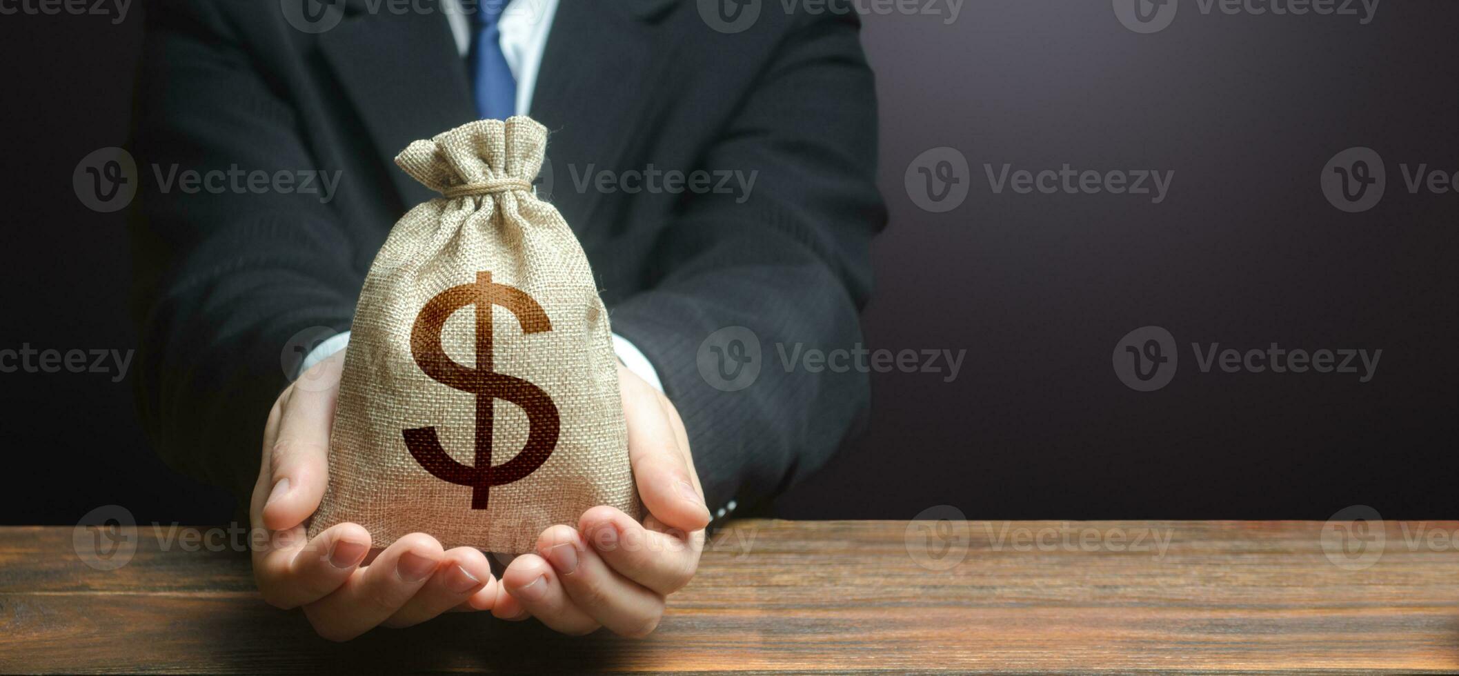 Businessman holds out dollar money bag. Getting a grant. Mortgage 