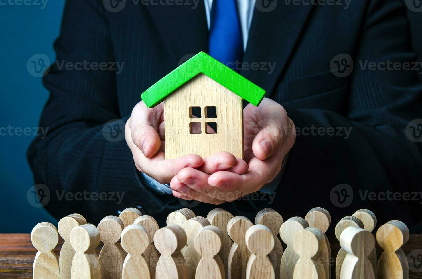 A man presents a house to people. Offer an affordable mortgage loan for home purchase. State guaranteed housing. Providing social real estate for people in need. Rent of apartments and houses. photo