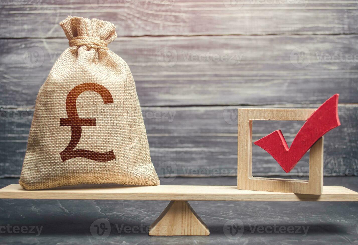 Red vote tick and a british pound sterling money bag on scales. Estimating cost of making a decision and consequences in the future. Corruption risks. Concept of lobbying for decisions and laws. photo