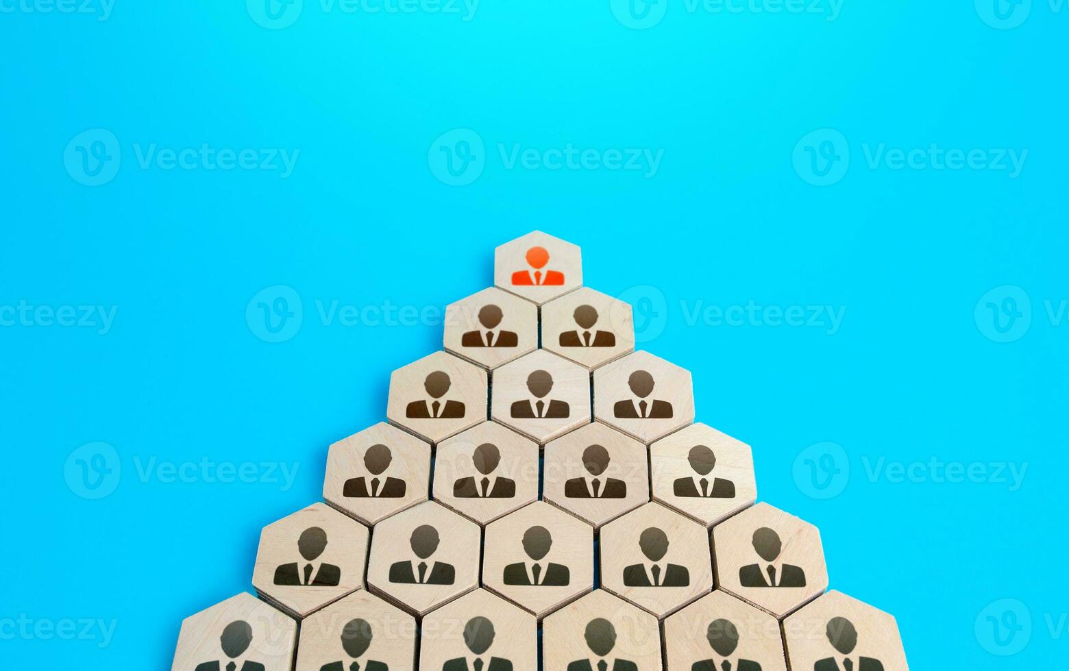 Leader on top of companys hierarchical pyramid. Traditional hierarchy concept. Superiors and subordinates. Meritocracy, corporate conformism. Personnel management. Cooperation and teamwork. photo