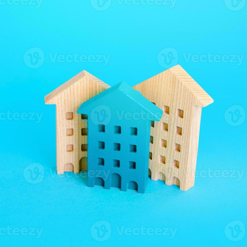 Figurines of multi-storey residential buildings. Housing and accommodation. Buying and selling real estate. Urbanization and city management. Mortgage loan. Repair and construction. photo