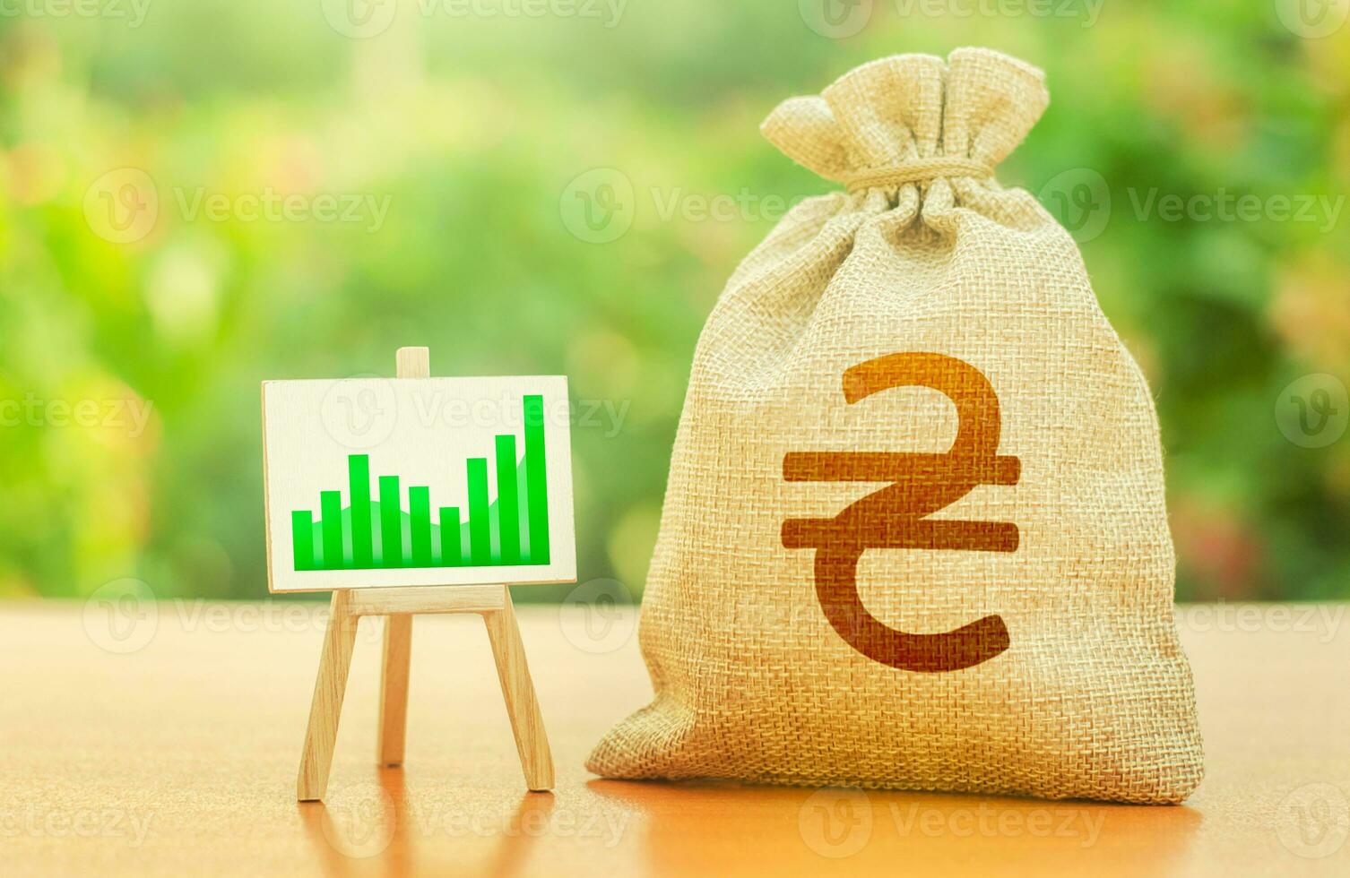 Ukrainian hryvnia money bag and growing chart easel. Investments in economy, post-war reconstruction. Rebuilding and revitalizing the economy after a period of conflict, growth and prosperity photo