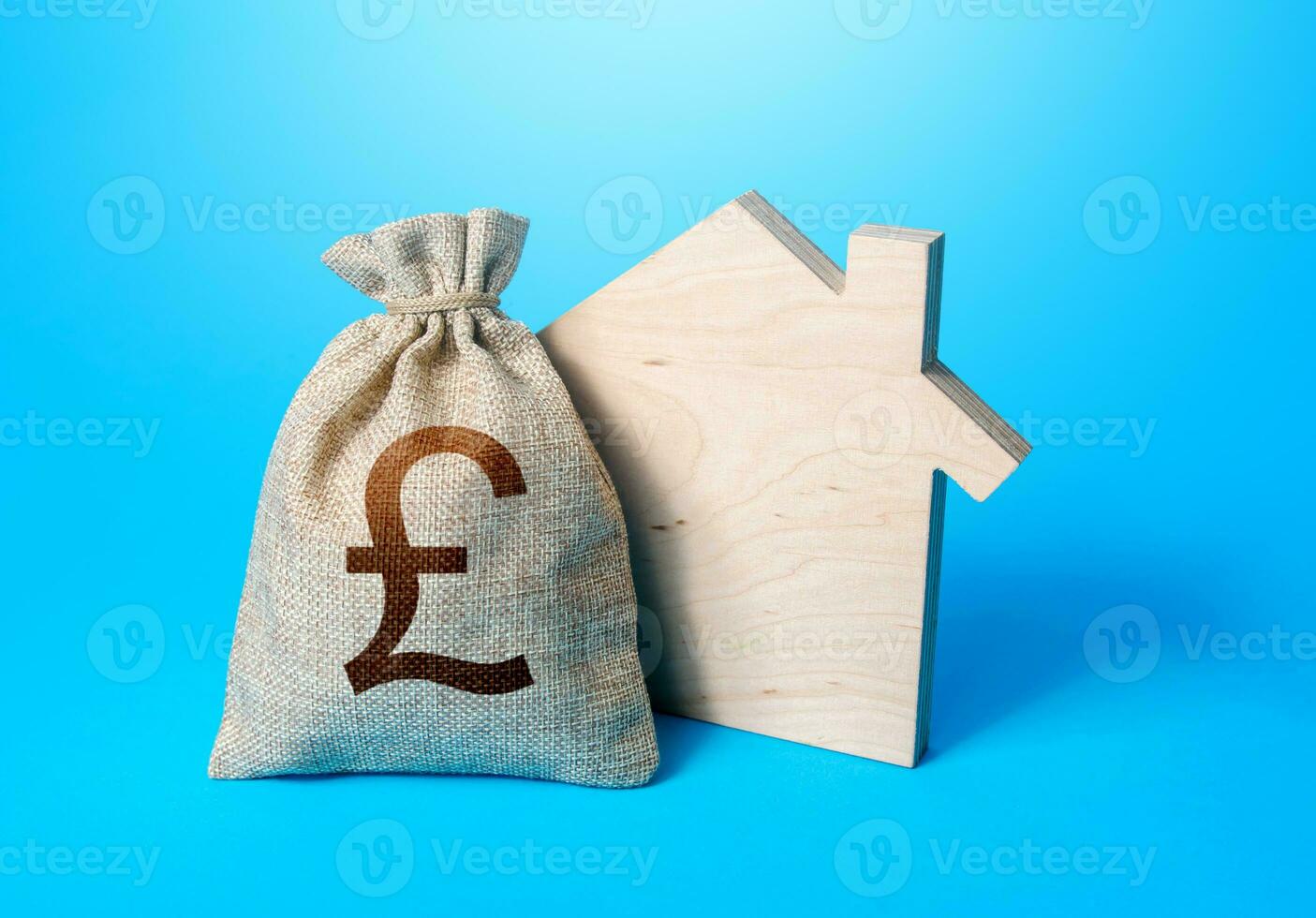 House silhouette and a british pound sterling money bag. Mortgage loan. House project development. Rental business. Property appraisal. Home purchase, investment in real estate construction. photo