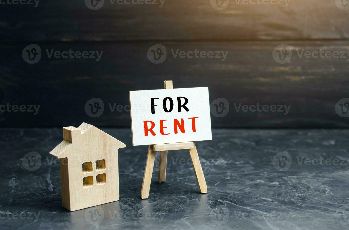 House figurine and sign for rent. Real estate realtor services. Legal procedure for concluding a contract. Investment in rental business. Purchase of housing for rent. Profit and payback forecasting. photo