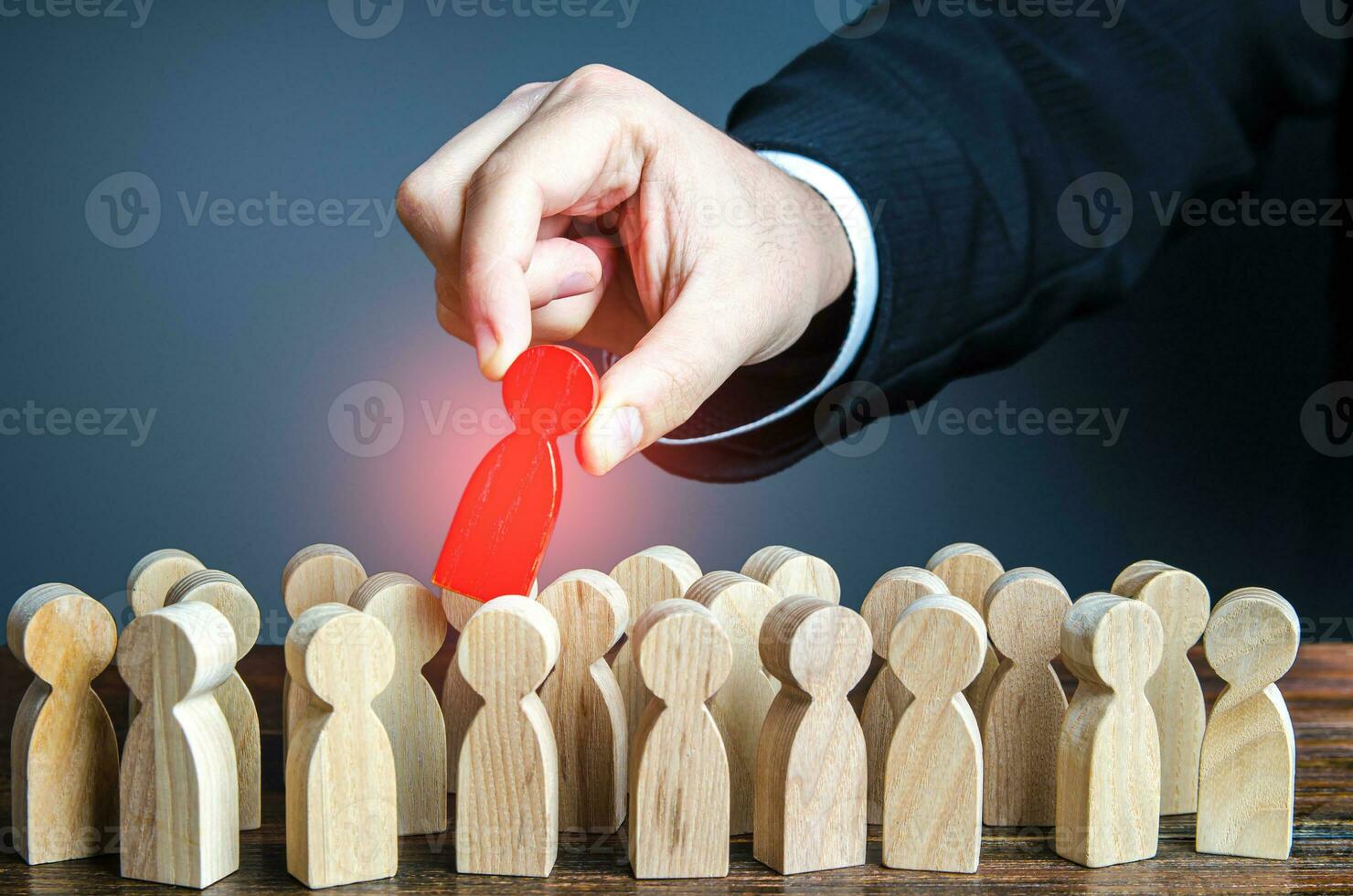 Hand pulls red man out of group. Dismissal, weak link. Identify the culprit among the suspects. Identify the infected person. Zero patient of new strain. Identifying intruder. Collective immunity. photo