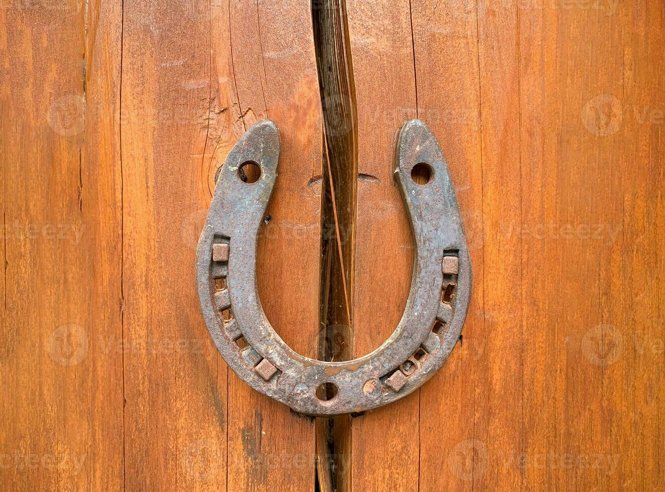 Horseshoe on a wooden crack. The concept of good luck and safety. Protect from destruction, failures and misfortunes. Superstitions and beliefs. Problem solution. Strengthening and security. Insurance photo