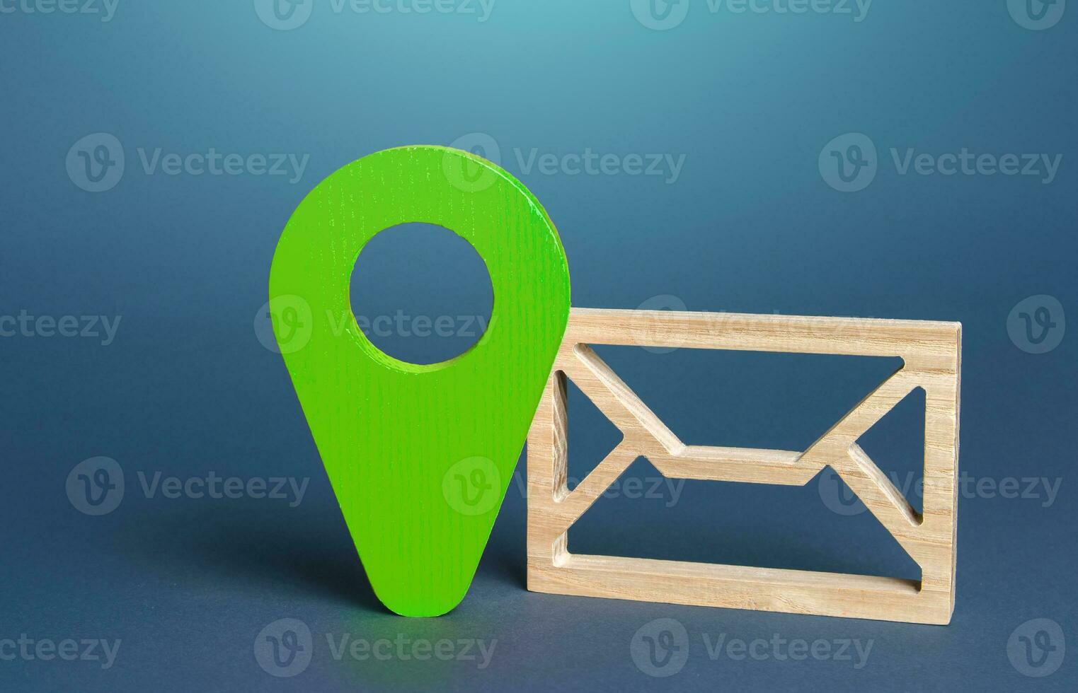 Envelope symbol and geolocation sign in green. Sending or receiving information, messages, or notifications with a geographic context. Eco-friendliness, sustainability practices photo