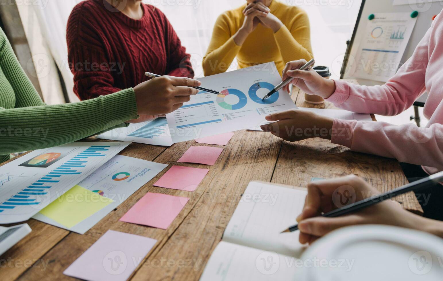 Financial analysts analyze business financial reports on a digital tablet planning investment project during a discussion at a meeting of corporate showing the results of their successful teamwork. photo