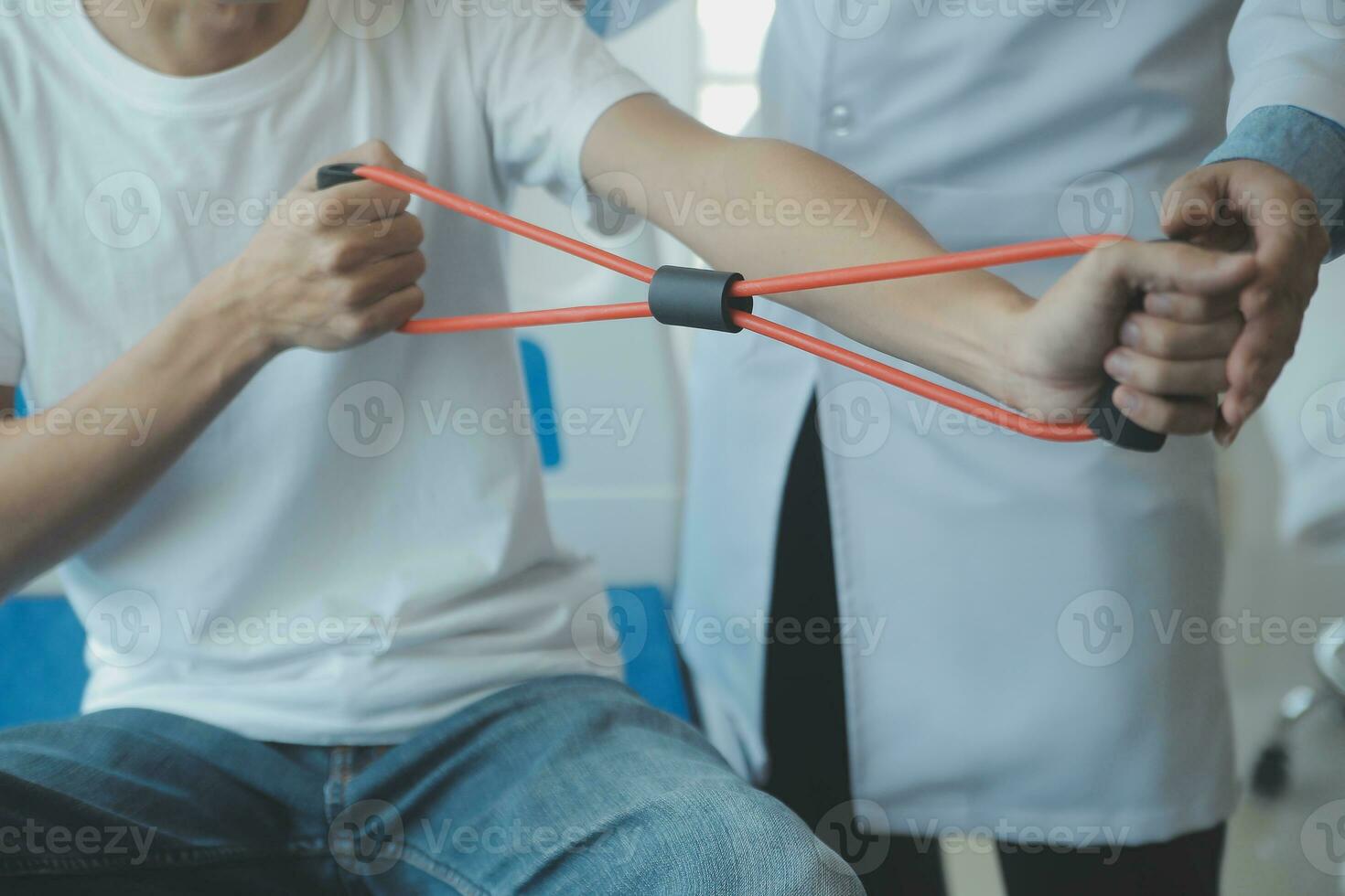 Doctor or physical therapist examines back pain and spinal area to give advice within the rehabilitation center. photo