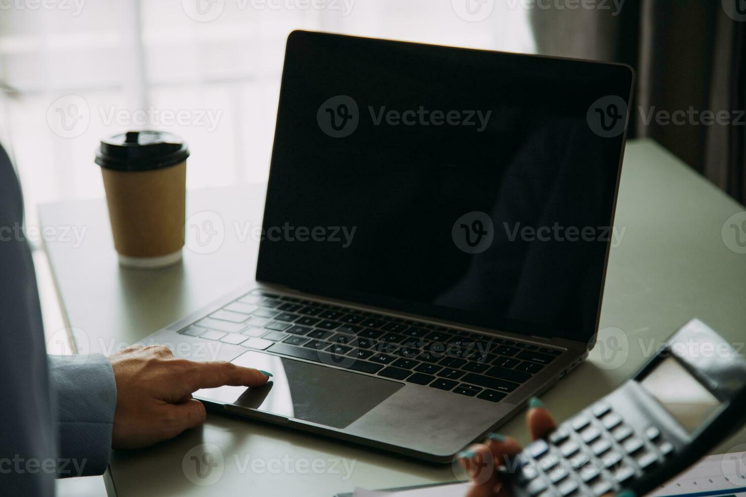 Young adult happy smiling Hispanic Asian student wearing headphones talking on online chat meeting using laptop in university campus or at virtual office. College female student learning remotely. photo