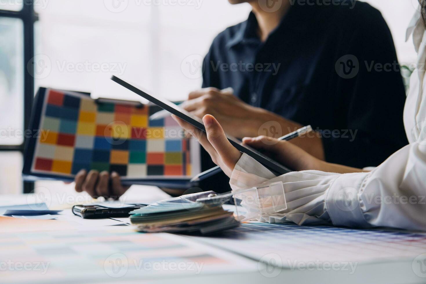 Close up ux developer and ui designer brainstorming about mobile app interface wireframe design on table with customer breif and color code at modern office.Creative digital development agency photo