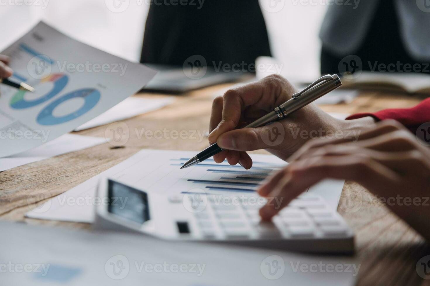 Financial analysts analyze business financial reports on a digital tablet planning investment project during a discussion at a meeting of corporate showing the results of their successful teamwork. photo