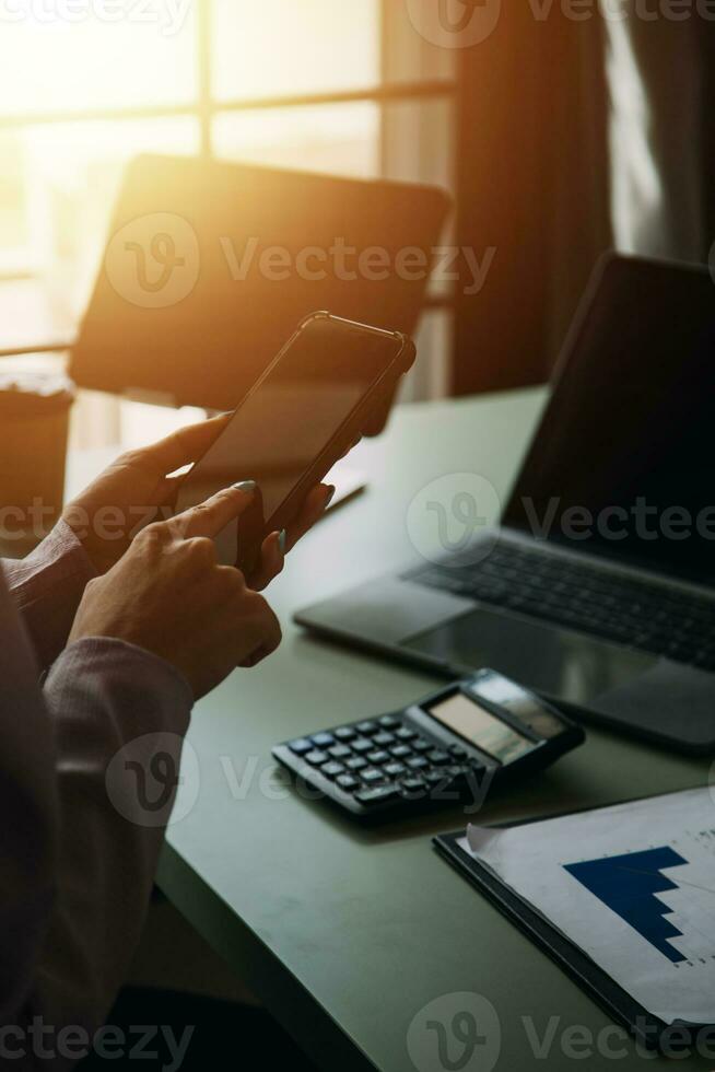Close up of Business team analyzing income charts and graphs with modern laptop computer. Business analysis and strategy concept. photo