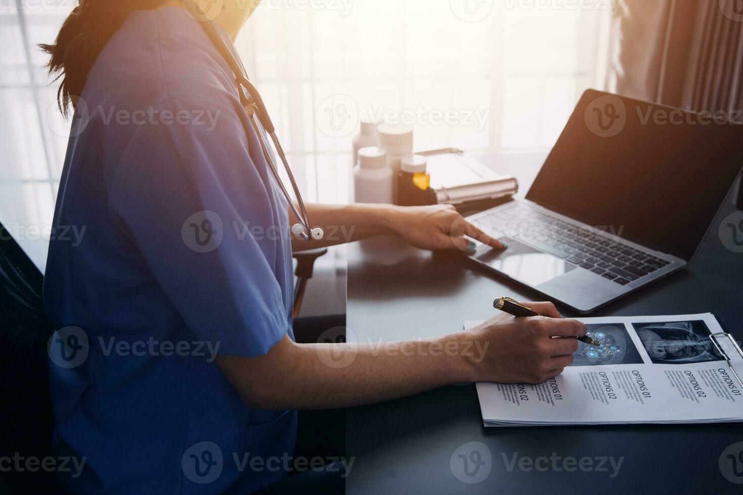 Doctor hand holding pen writing patient history list on clipboard about medication and treatment. photo