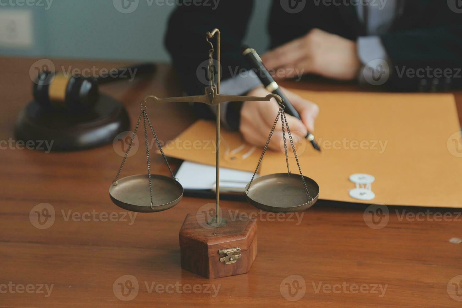 Business and lawyers discussing contract papers with brass scale on desk in office. Law, legal services, advice, justice and law concept picture with film grain effect photo