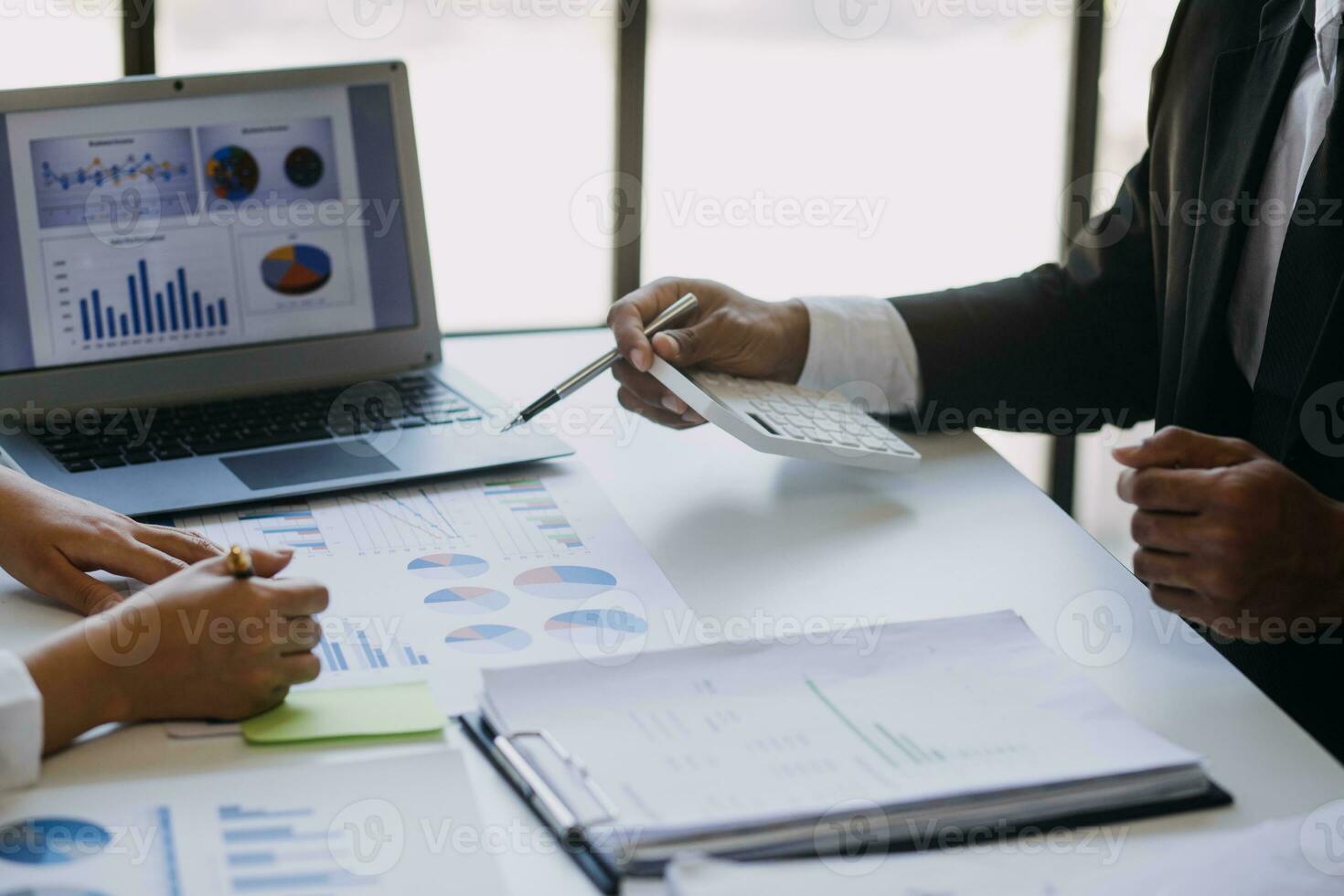 A couple is approaching a housing project to buy, and they are discussing details and advice with a salesperson in a housing project. Real estate trading ideas with couples. photo