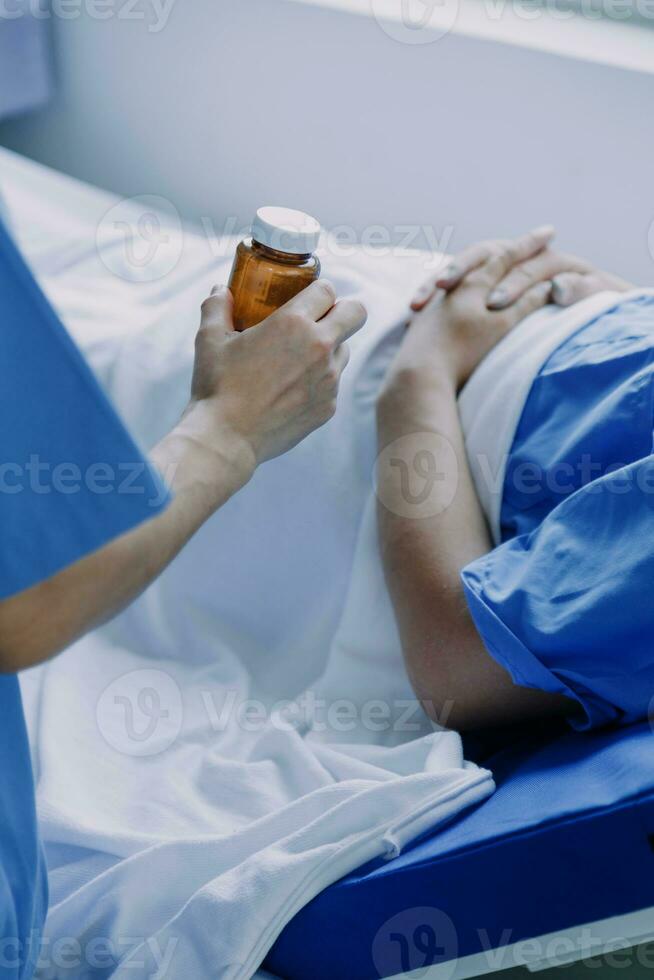 doctor check up after surgery. doctor touching patient hand and consoling. photo