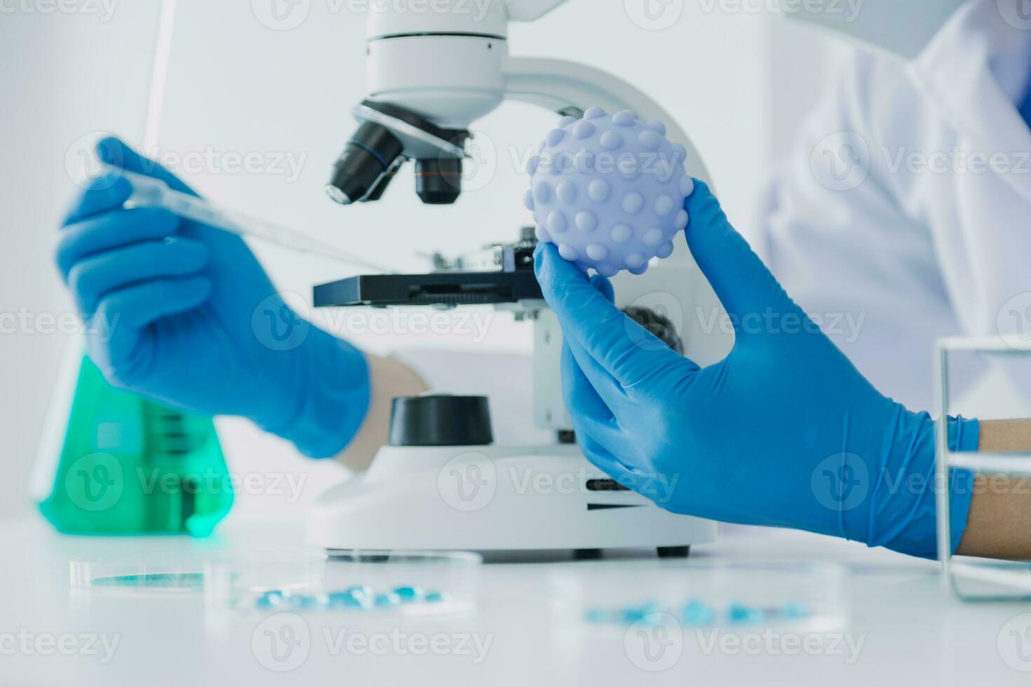 biochemical research scientist team working with microscope for coronavirus vaccine development in pharmaceutical research labolatory, selective focus photo