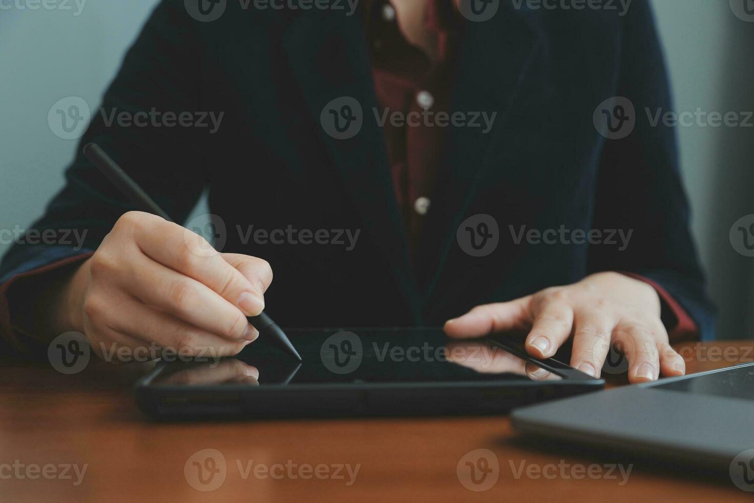 Asian Businesswoman Using laptop computer and working at office with calculator document on desk, doing planning analyzing the financial report, business plan investment, finance analysis concept. photo