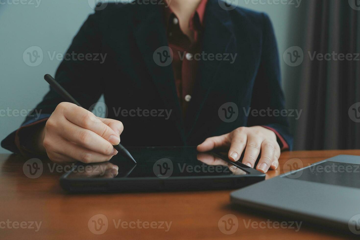 Asian Businesswoman Using laptop computer and working at office with calculator document on desk, doing planning analyzing the financial report, business plan investment, finance analysis concept. photo