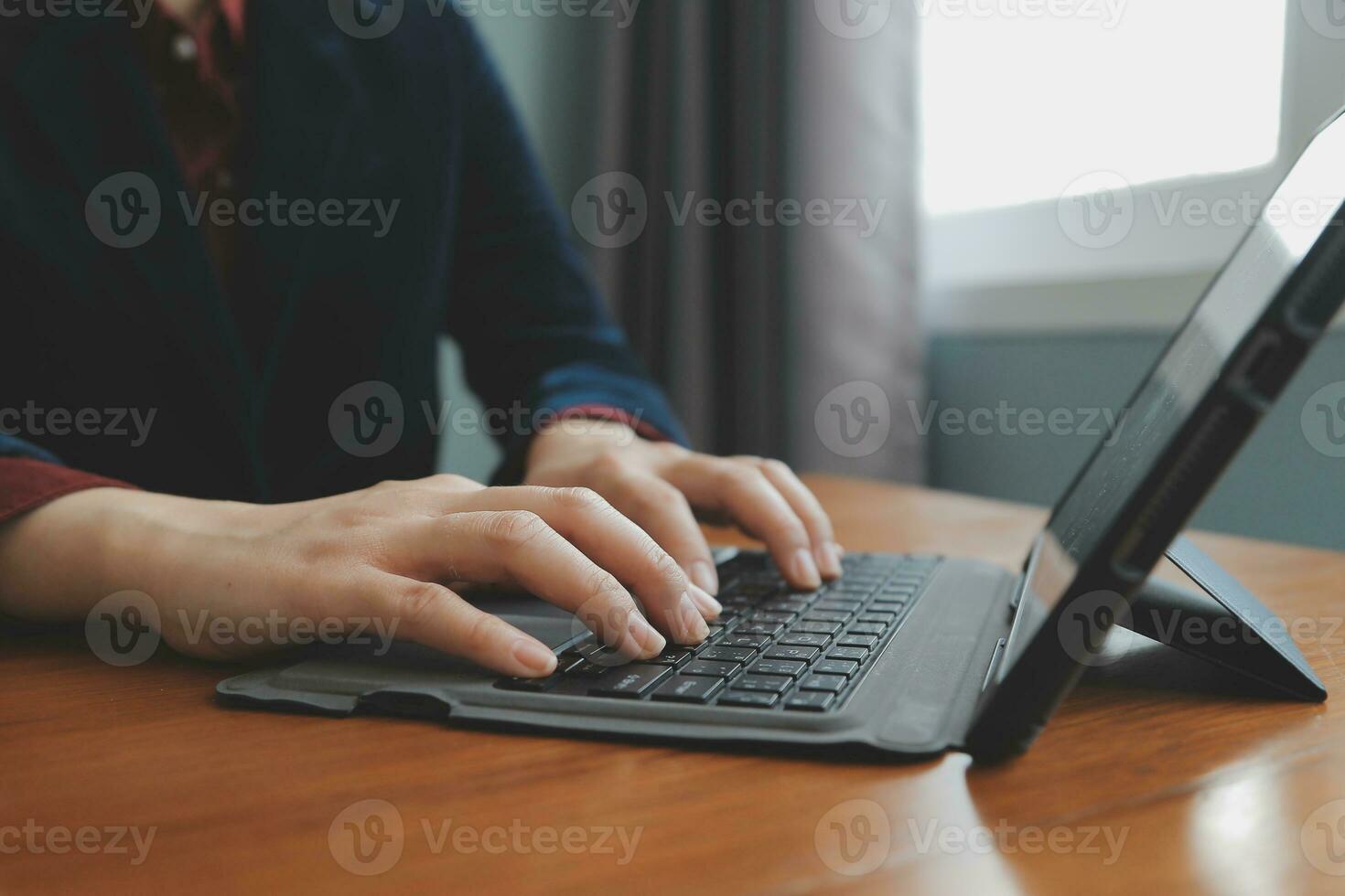 Asian Businesswoman Using laptop computer and working at office with calculator document on desk, doing planning analyzing the financial report, business plan investment, finance analysis concept. photo